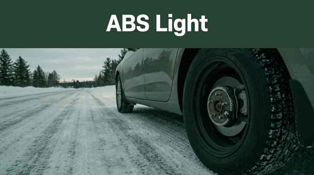 Banner reading 'ABS Light' over a car on a snowy icy road, focusing on the rear wheel and brake assembly